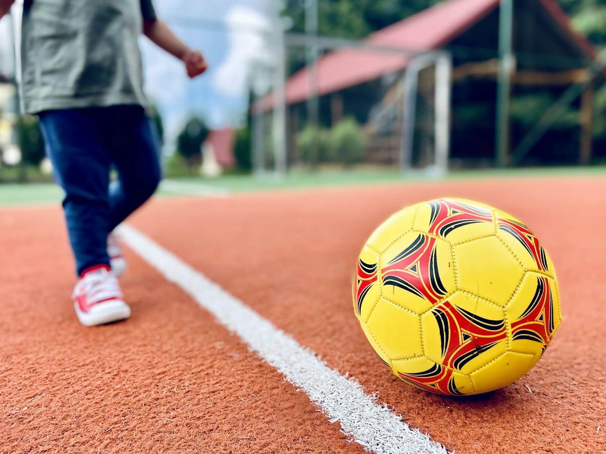 Soccer ball on grass, representing interactive football quizzes